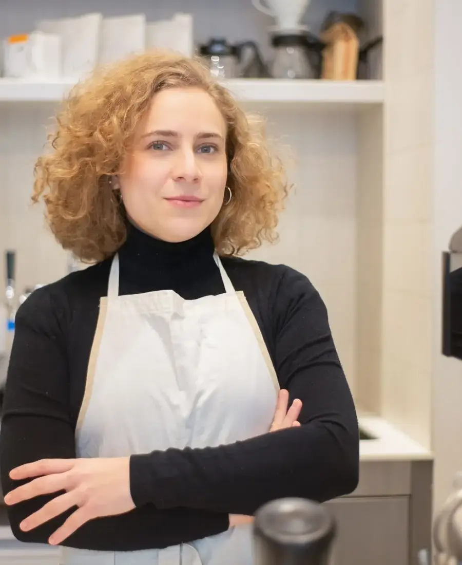 A smiling young barista at work